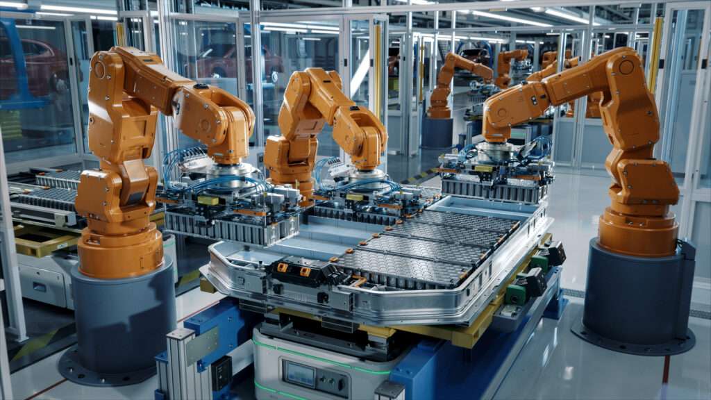Advanced Orange Industrial Robotic Arms inside Automotive Plant assembling batteries.